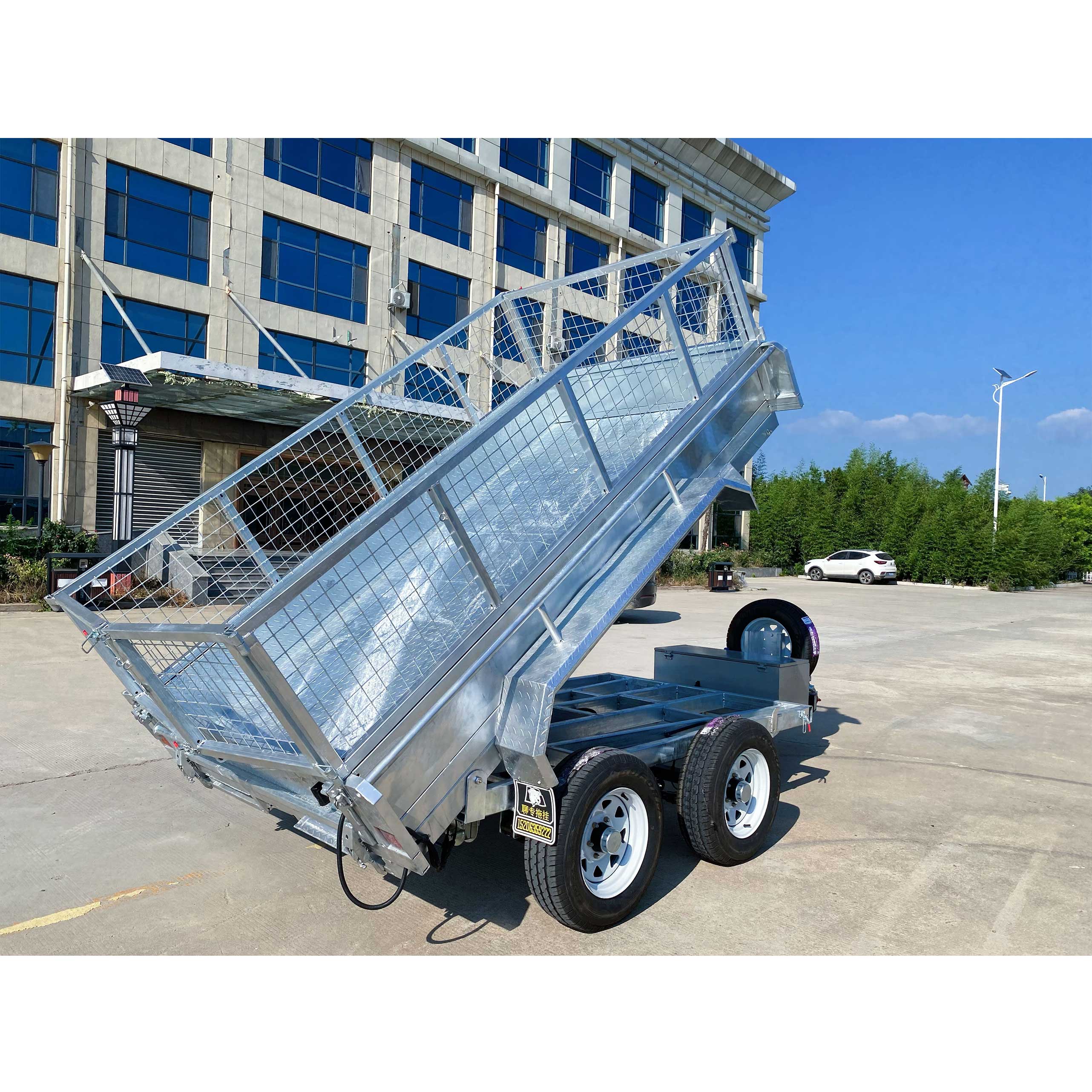 Double-axis tipping cage trailer with tires