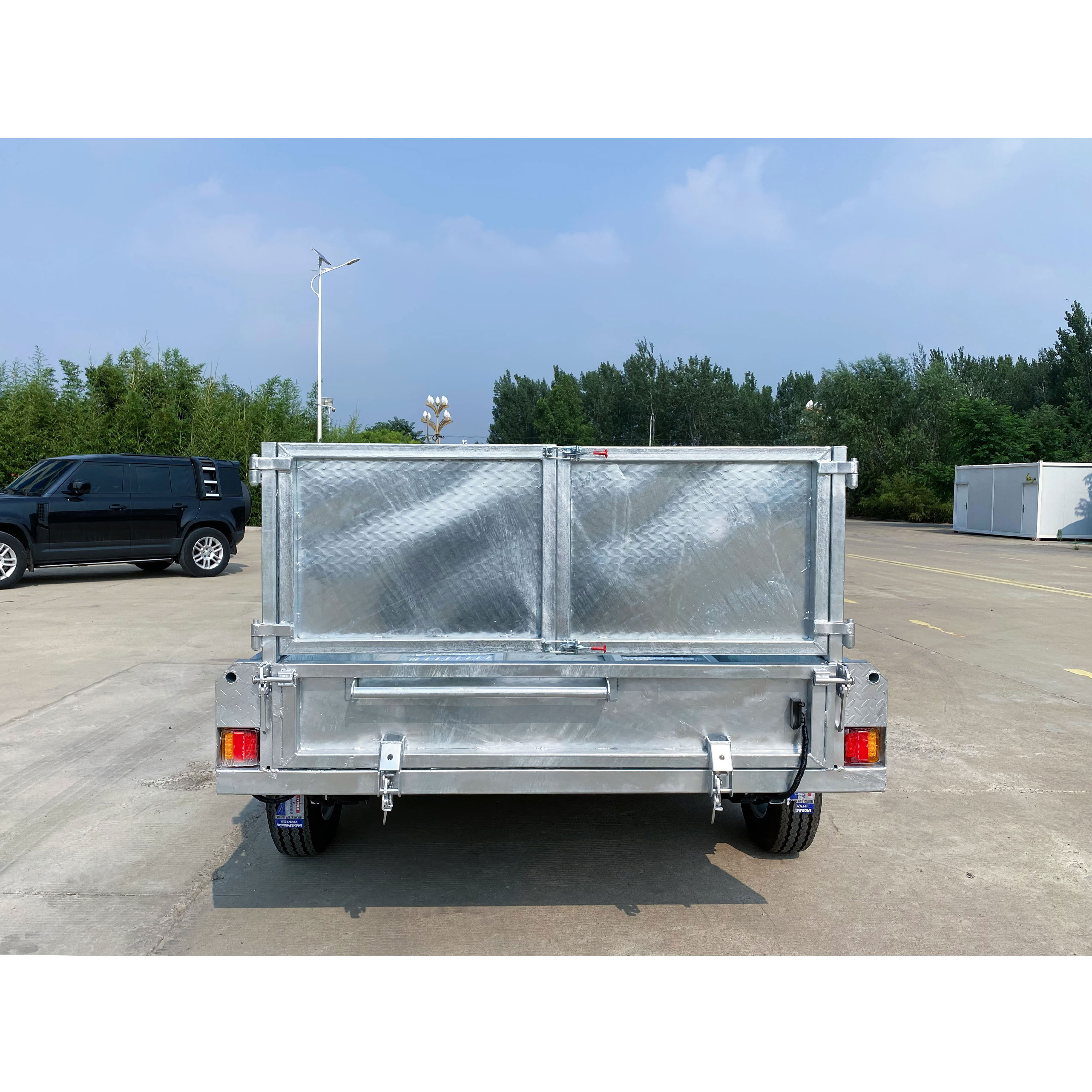 Double-box type self-unloading hydraulic agricultural trailer