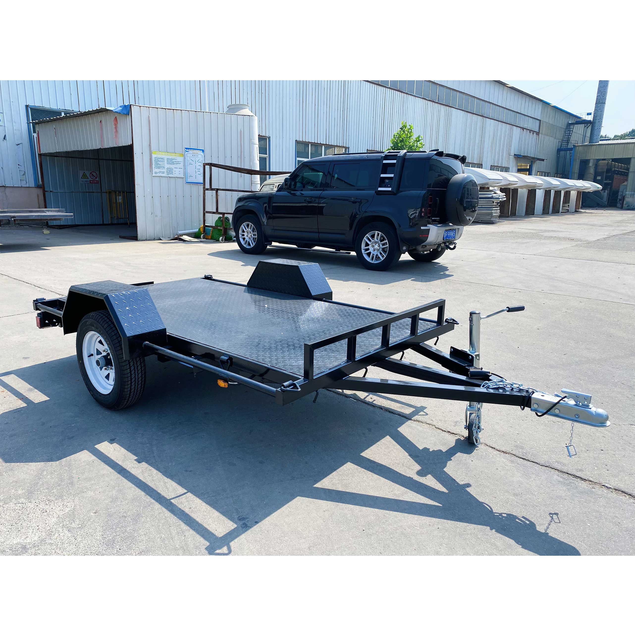 Single axle black flatbed trailer