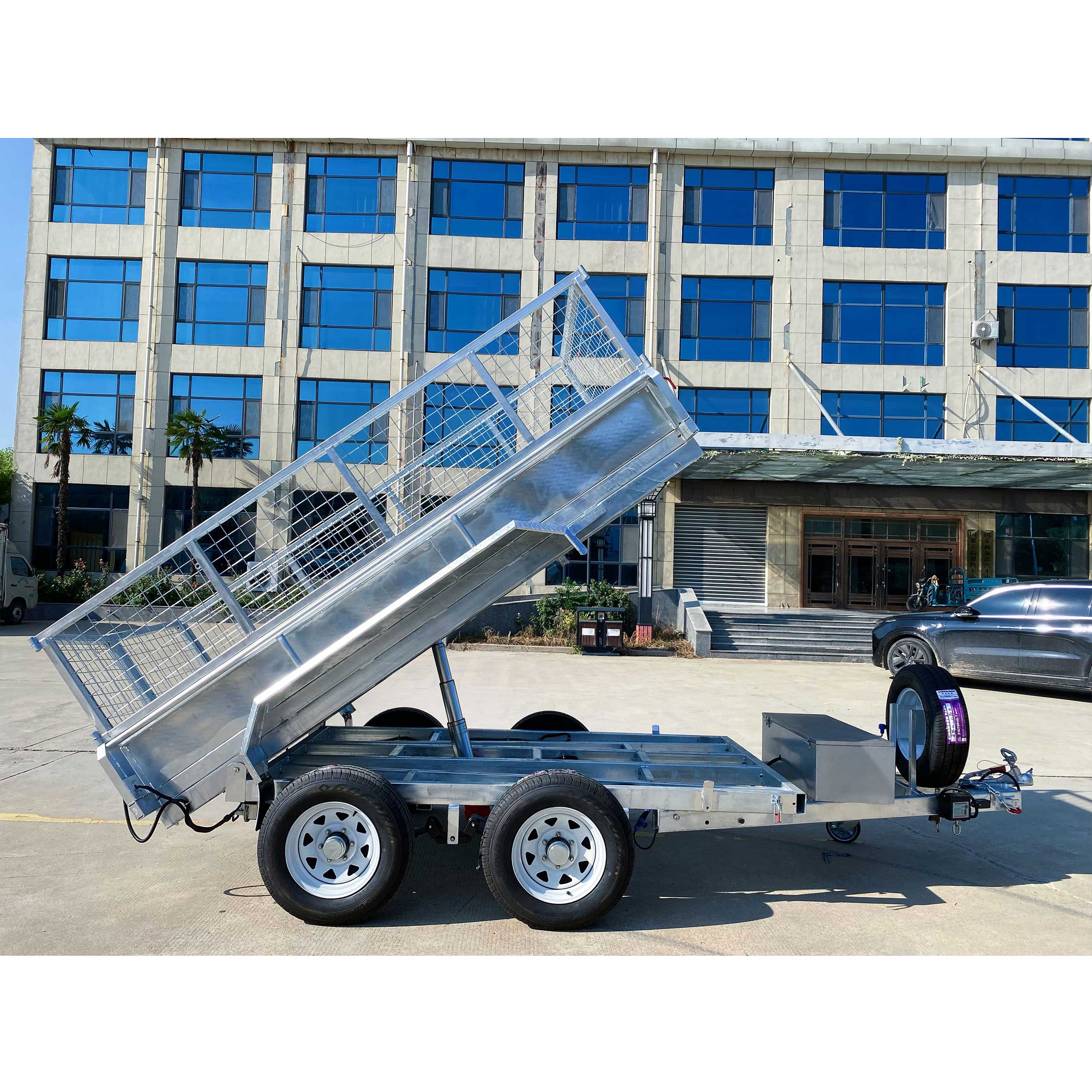 Double-axis tipping cage trailer with tires