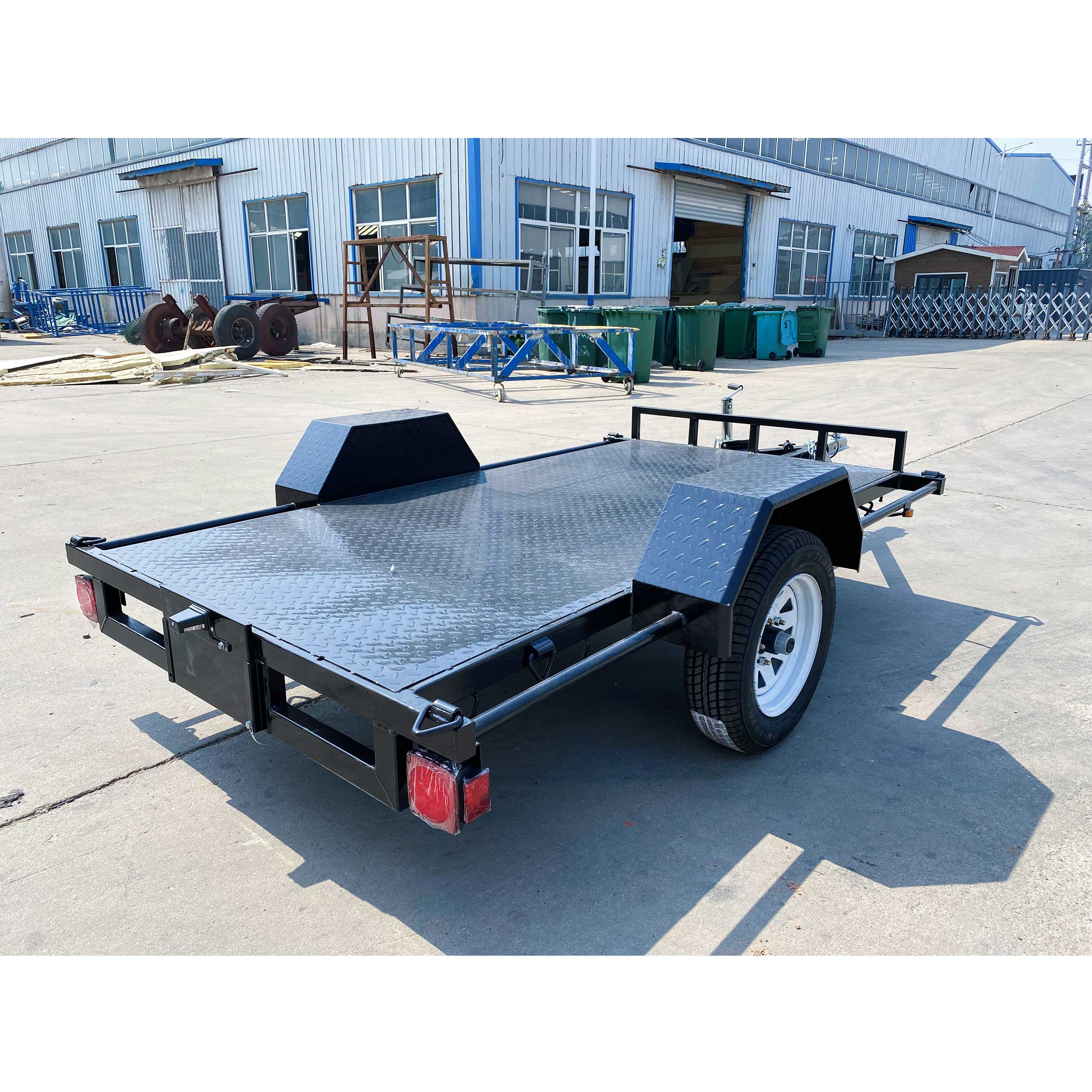 Single axle black flatbed trailer